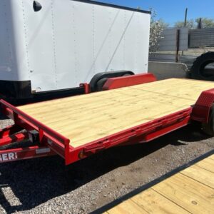 Red flatbed utility trailer parked